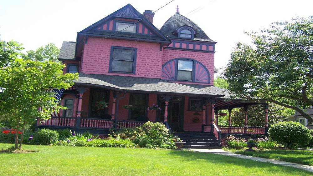 Queen Anne Victorian finished in rose and deep plum, with fan and gable details