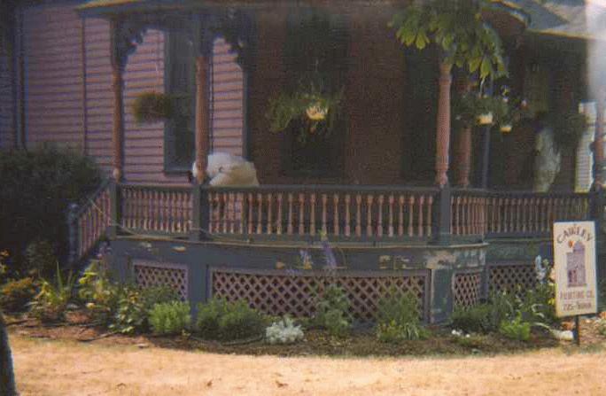 The same Victorian porch mid-job, with the Cawley sign out front