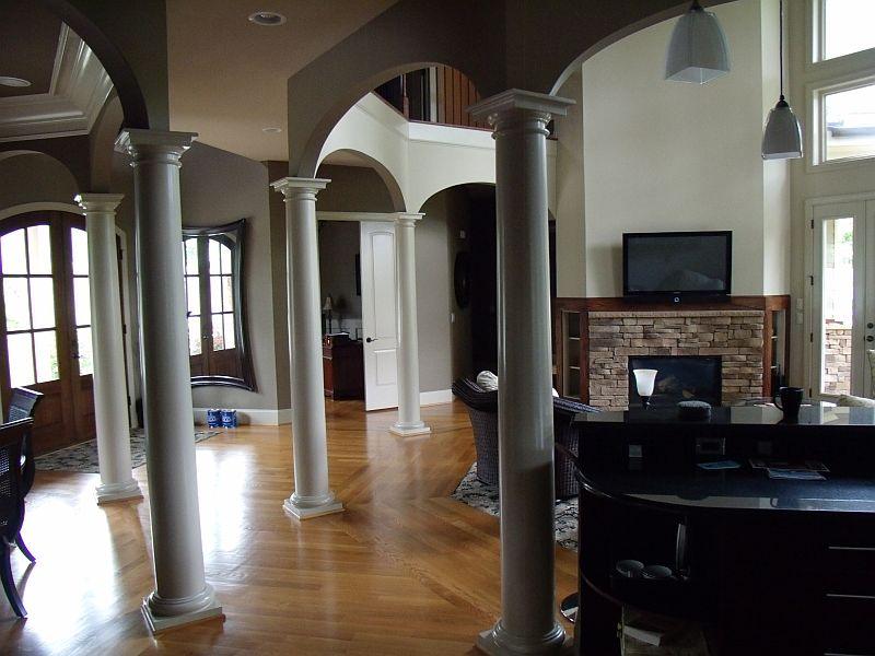 Great room with painted columns, arches and accent walls