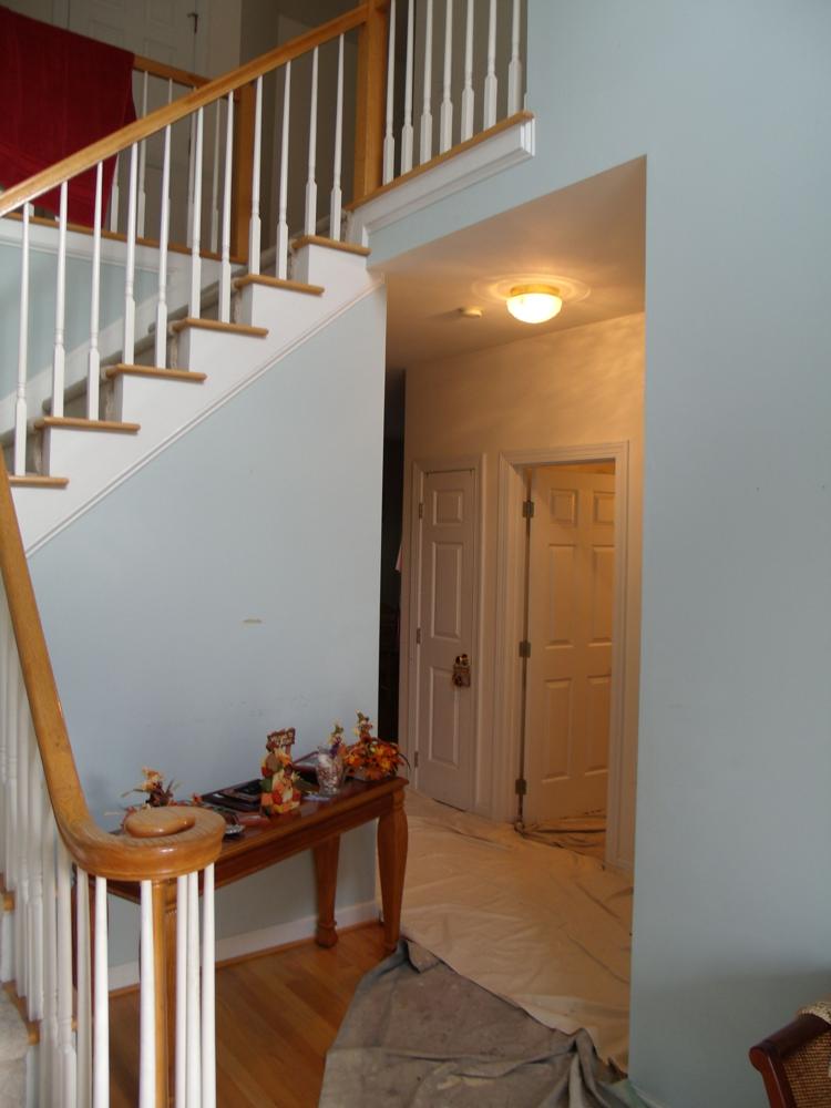 Two-story foyer and stairwell, drop cloths down mid-job